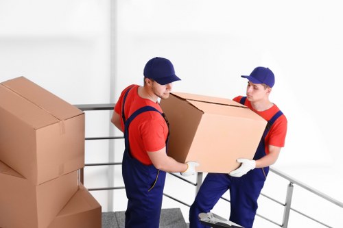 Local removal van and movers working on a street in Islington