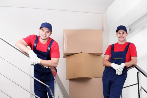 Removal team handling boxes and furniture in a local Islington flat