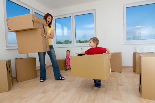 Moving team transporting boxes and furniture during an Islington relocation