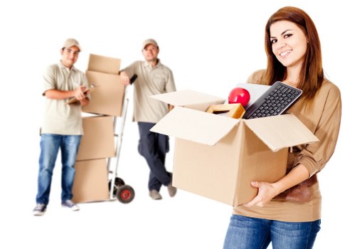 Packed moving boxes and furniture ready for transport in Islington
