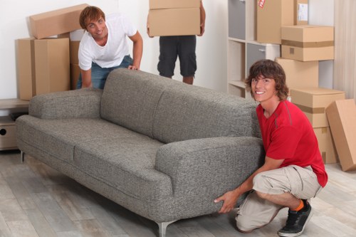 Packed moving boxes and furniture prepared for collection in Islington